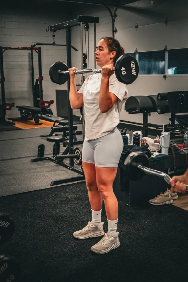 Member doing a barbell exercise at Visualize Fitness in Smithtown